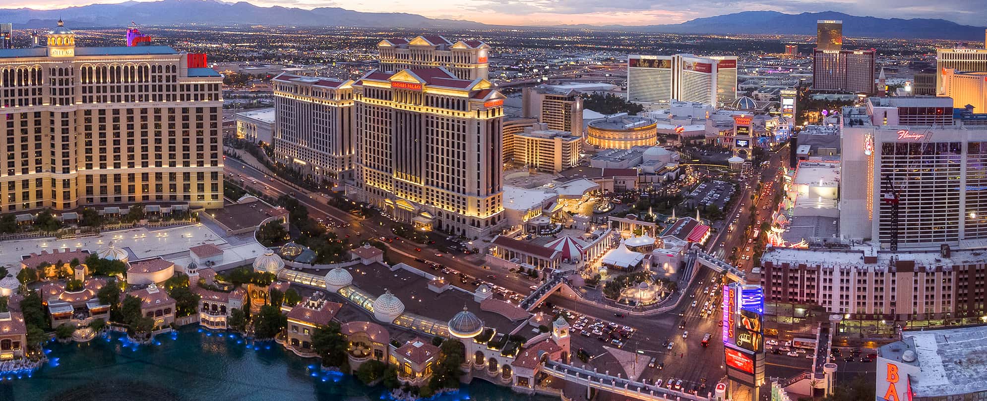 Caesar's Palace and the Las Vegas Strip lit up at sunset.