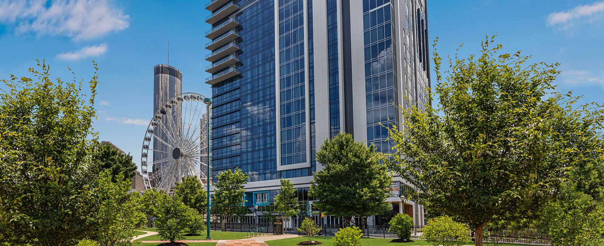 The Margaritaville Atlanta resort with verdant landscaping and a Ferris wheel 